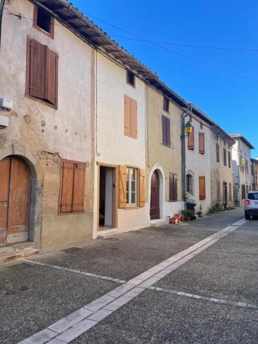 an empty street in a town with buildings at A la petite maison de village in Sabarat