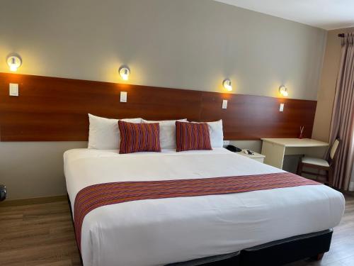 a hotel room with a large bed in a room at Hotel San Pedro Plaza in Cusco