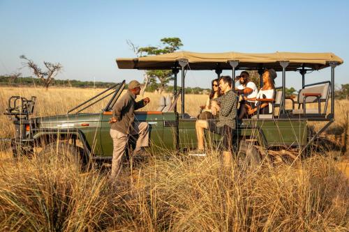a group of people in a vehicle in a field at Lejwe La Metsi Private Reserve in Bela-Bela