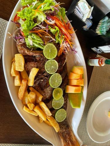 a plate of food with a sandwich and salad and chips at Cumbuco - VGSun Apartment 402 in Cumbuco