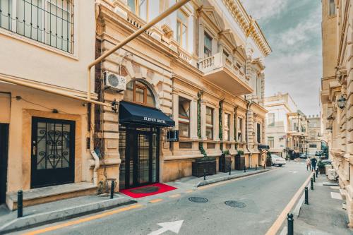 an empty street in a city with buildings at Eleven Hotel Baku in Baku