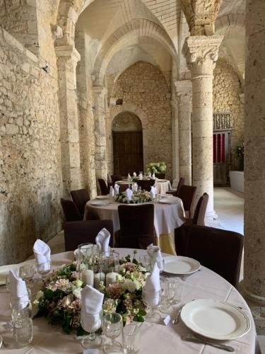 a dining room with tables with flowers and candles at Demeure des Vieux Bains in Provins