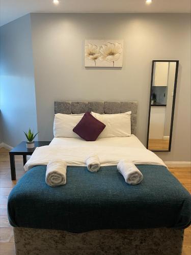 a bedroom with a bed with towels on it at Showcase Apartments – Kimberley House in Leicester