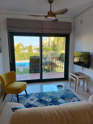 a living room with a couch and a glass table at Vera Playa Naturista Michel in Vera