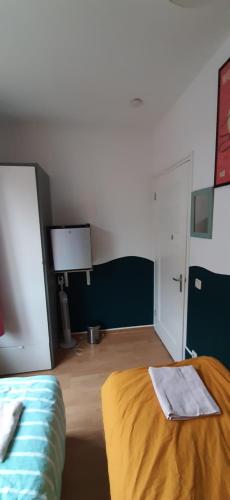 a bedroom with a bed and a room with avertisement at MICHELLE, not for parties, not a hotel, room with shared bathroom, no kitchen in Amsterdam