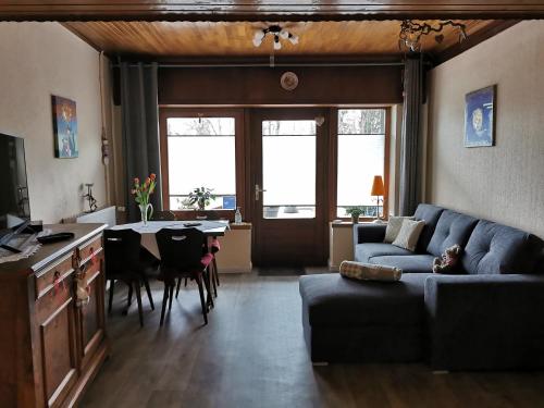 a living room with a couch and a table at Au repos des remparts in Wissembourg