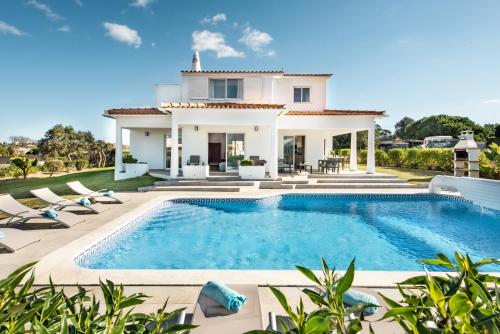 a villa with a swimming pool and a house at Silva by Algarve Villa Holidays in Albufeira