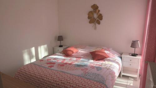 a small bedroom with a bed and two night stands at Sol-y-Days Grau Village, Superbe maison de vacances avec 3 chambres et un bel espace exterieur aménagé in Le Grau-du-Roi