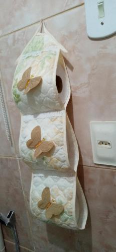 three towels with butterflies on them on a table at Hostel Cidade Nova in Rio de Janeiro
