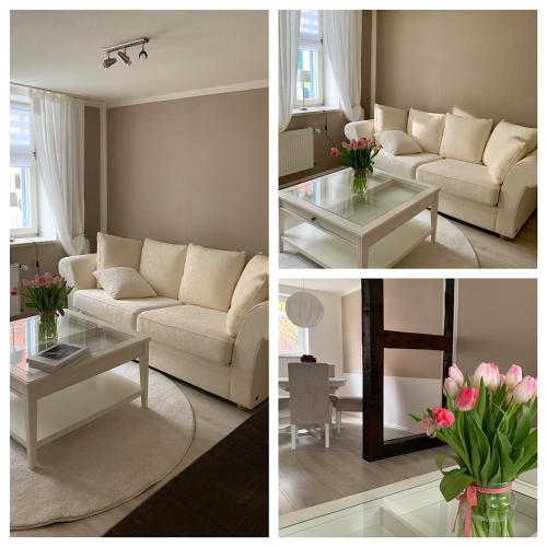 a living room with a white couch and a table at Ferienhaus LiebensWert an der St Stephan Kirche Tangermünde in Tangermünde