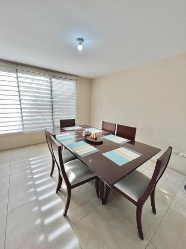 a dining room with a table and chairs at VFC Suites Cuenca - Ecuador in Cuenca