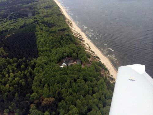 an aerial view of a house on an island in the water at Forsthaus Langenberg in Bansin