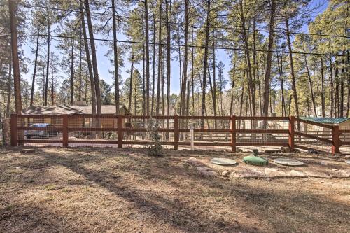 a wooden fence with some frisbees on the ground at Near Tonto National Forest Dog-Friendly Cabin! in Payson