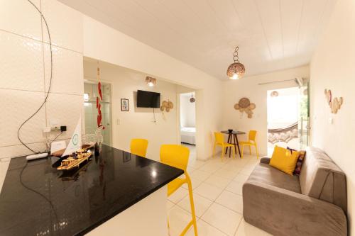 a living room with a couch and a table at Condomínio Praias de Maragogi & Casas Deluxe in Maragogi
