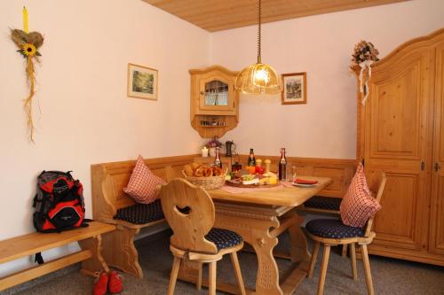 a kitchen with a wooden table and chairs at Pension Vendel in Pfronten