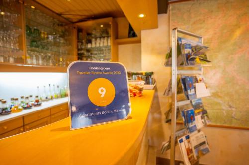 a sign on a counter in a store at Apartments Bohinj Mavrica in Bohinj