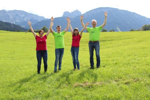 a group of people standing in a field with their hands in the air at Pension Vendel in Pfronten