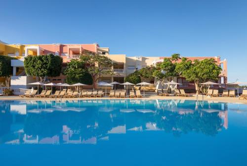 a large swimming pool with chairs and umbrellas at Allegro Isora in Puerto de Santiago
