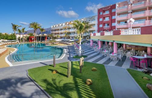 a resort with a swimming pool and a hotel at Allegro Isora in Puerto de Santiago