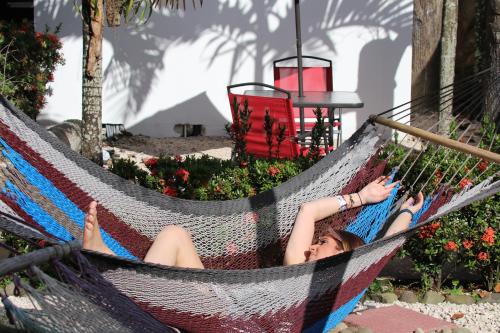a woman is laying in a hammock at Arenal Poshpacker in Fortuna