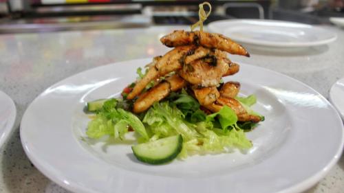 a plate of food with a salad on a table at Reef Hotel in Johannesburg