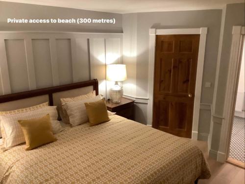 a bedroom with a bed and a lamp and a door at Puffin Lodge Accomodation in Killybegs