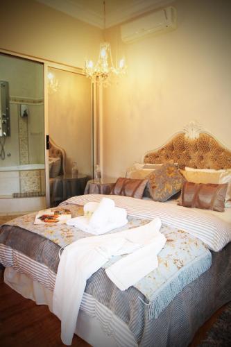 a bedroom with a large bed with towels on it at Victoria Manor in Upington
