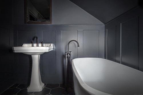 a bathroom with a sink and a bath tub next to a sink at The Albion Rooms in Margate