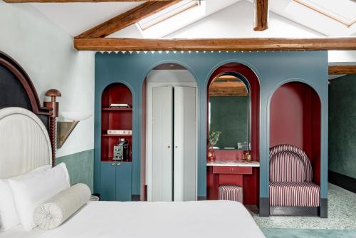 a bedroom with a bed and a vanity with a mirror at Il Palazzo Experimental in Venice