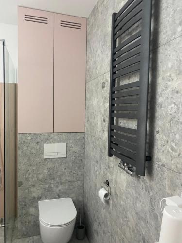 a bathroom with a white toilet and a sink at Flaming Apartment Gdańsk Wrzeszcz in Gdańsk