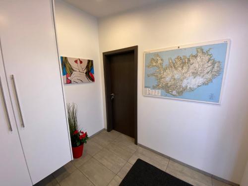a hallway with a map on the wall at Ace Guesthouse in Keflavík