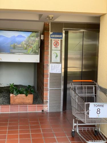 a shopping cart in front of a hotel entrance at Apartamento amoblado nuevo in Pereira