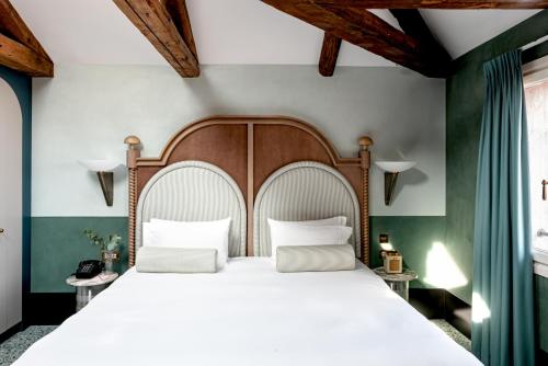 a bedroom with a large bed with two pillows at Il Palazzo Experimental in Venice