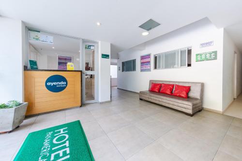 a lobby of a hospital with a couch and red pillows at Ayenda Panamericana in Manizales