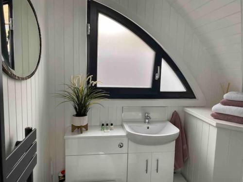 a bathroom with a sink and a large window at Orkney Lux Lodges - Brinkies Retreat in Stromness