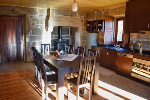 eine Küche mit Tisch und Stühlen in einem Zimmer in der Unterkunft Casa Florestal, na Branda da Bouça dos Homens in Gavieira
