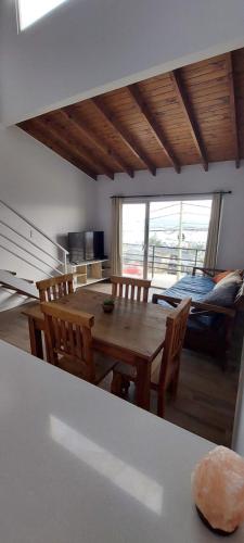 a kitchen and dining room with a table and chairs at Aparahik in Ushuaia