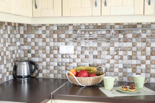 a kitchen with a basket of fruit on a counter at Irida Vacation suites in Kastraki Naxou