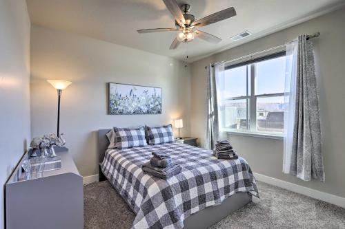 een slaapkamer met een bed, een plafondventilator en een raam bij Family-Friendly Grand Junction House with Patio in Grand Junction