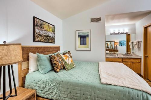 a bedroom with a bed and a bathroom at Cozy Vail Valley Townhome - Walk to Riverwalk! in Edwards