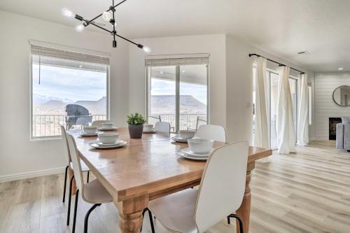 a dining room with a wooden table and white chairs at Luxe Family Condo with Mtn View and Resort Perks! in St. George