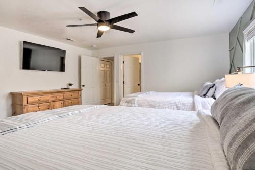 two beds in a bedroom with a ceiling fan at Luxe Family Condo with Mtn View and Resort Perks! in St. George