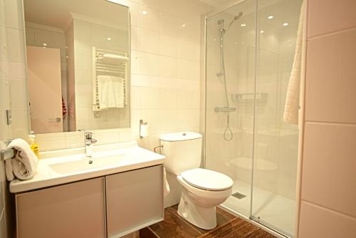 a bathroom with a toilet and a glass shower at Go Donosti Santa Maria in San Sebastián
