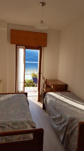 1 Schlafzimmer mit 2 Betten und Meerblick in der Unterkunft casa Leo in Magugnano-Marniga