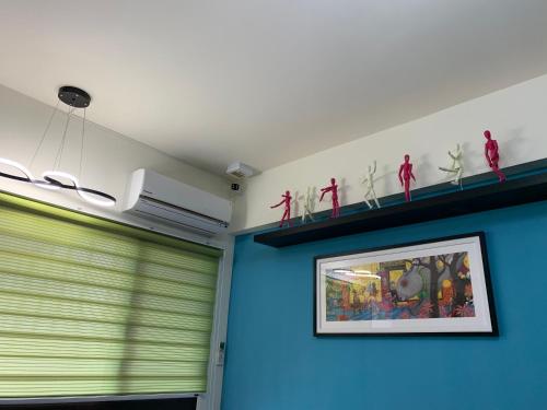 a room with blue walls and a picture on the wall at Duke 369 in Donggang