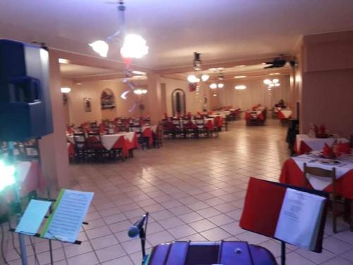 a dining room with tables and chairs in a restaurant at Hotel Grazia Ristorante in LʼAquila
