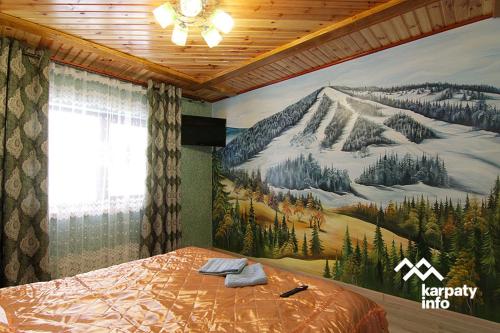 a bedroom with a mountain mural on the wall at ЗОЛОТА РИБКА in Slavske