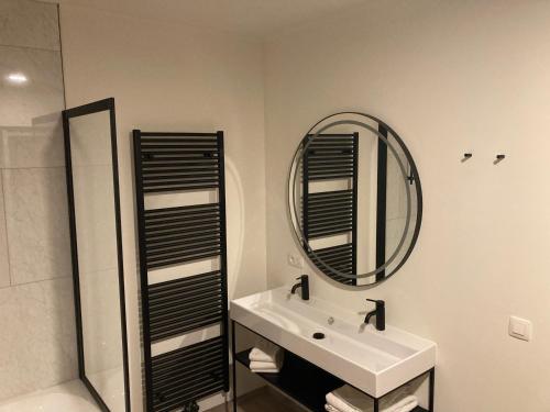 a white bathroom with a sink and a mirror at RS10 Turnhout in Turnhout