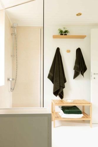 a bathroom with a shower and a sink with a towel rack at SOLE SPECIAL AP-DOUBLE SOFA BED with TOPPER in Muggia
