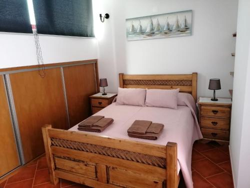 a bedroom with a bed with two towels on it at Di&Ana II - Alojamento Vila Viçosa in Vila Viçosa